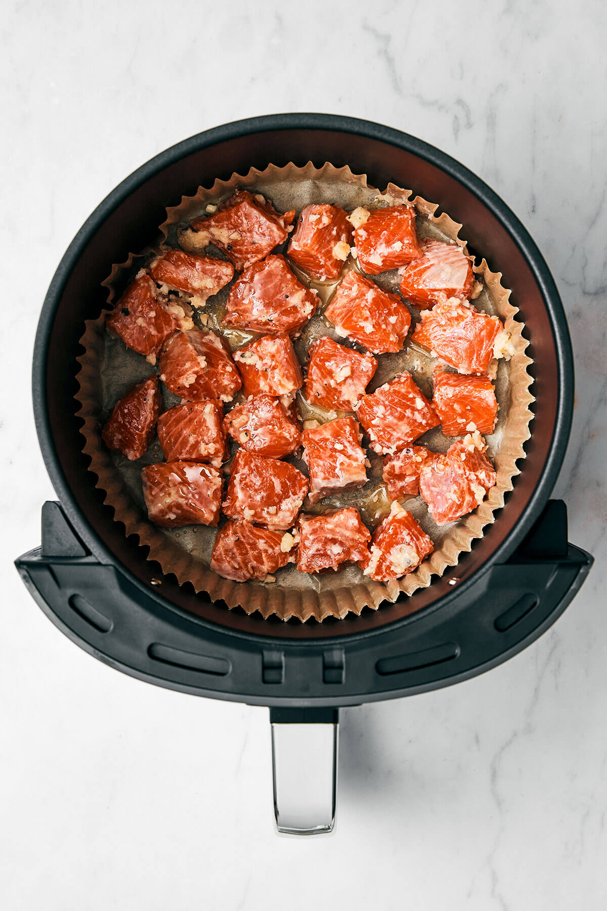 Putting salmon cubes in air fryer