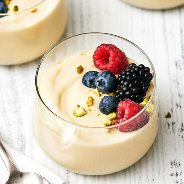 A glass of custard with fruit