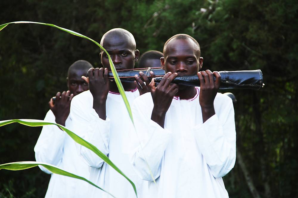 A group of folk performers plays a traditional trampet (Amakondere), a royal performance believed to have its origins in the tory of Koogere