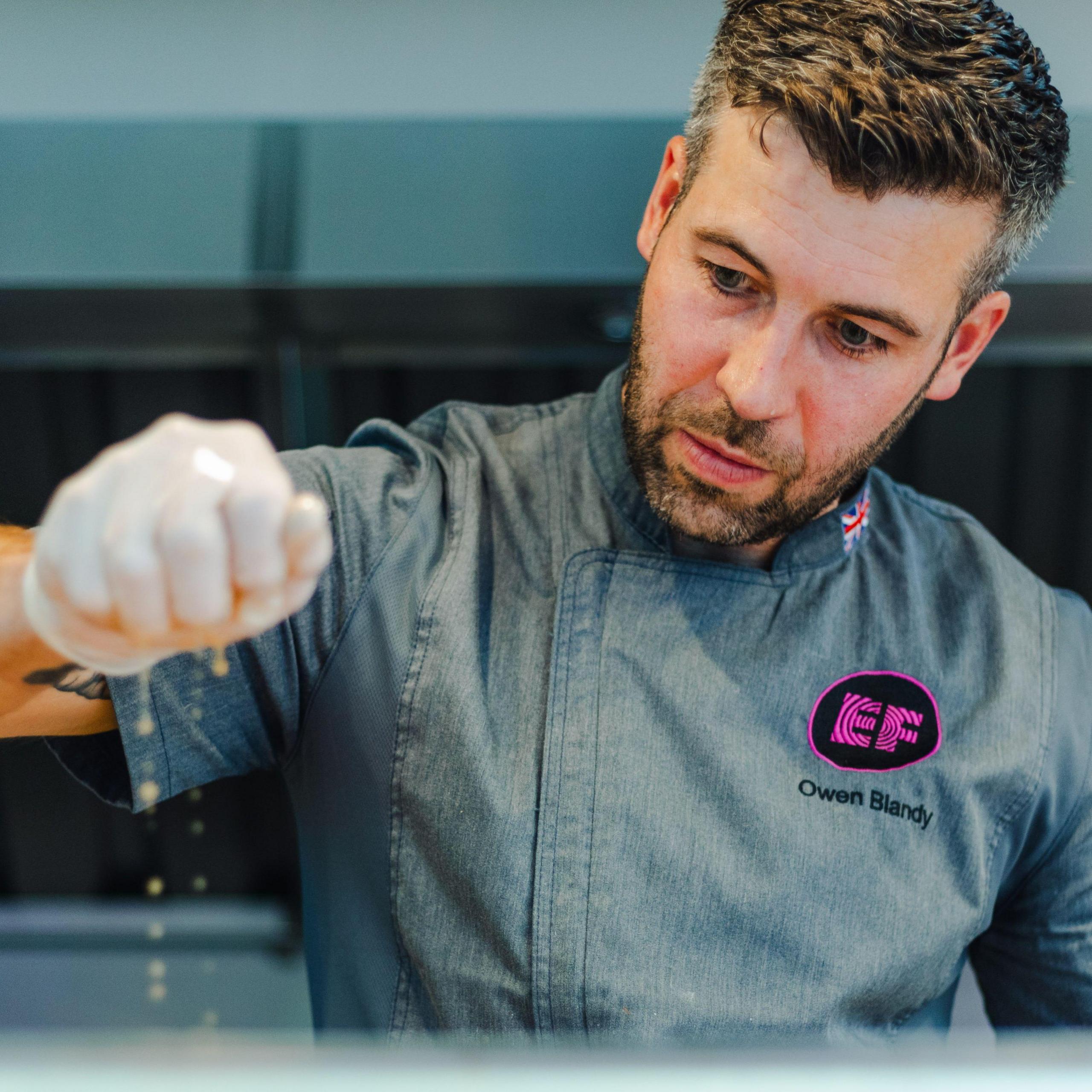 Chef Owen Blandy squeezes juice over food