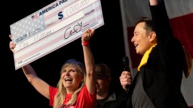 SpaceX and Tesla founder Elon Musk awarded Kristine Fishell with a $1 million check during the town hall at the Roxain Theater on October 20, 2024 in Pittsburgh, Pennsylvania