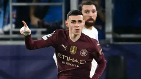 Phil Foden celebrates scoring in the Champions League