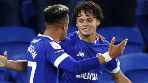 Cardiff's Perry Ng celebrates