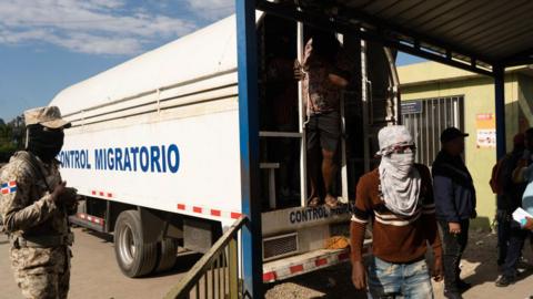 Haitian migrants seen at the back of a lorry belonging to the immigration enforcement service of the Dominican Republic