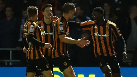 Chris Bedia celebrates scoring against QPR with his Hull City teammates