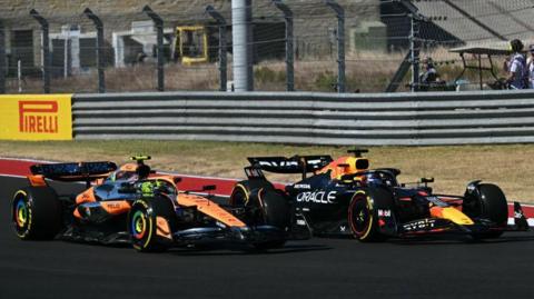 Max Verstappen goes up the inside of Lando Norris' McLaren at the first corner of the United States Grand Prix