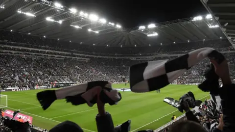 Newcastle United fans wave their scarves during the Carabao Cup