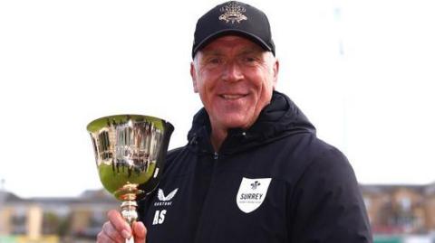 Alec Stewart holding the County Championship trophy