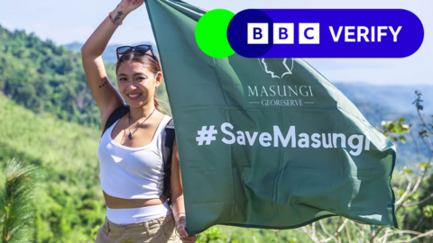 Filipino actress and singer Nadine Lustre holds a green flag with the hashtag #SaveMasungi on it, against a backdrop of lush rainforest