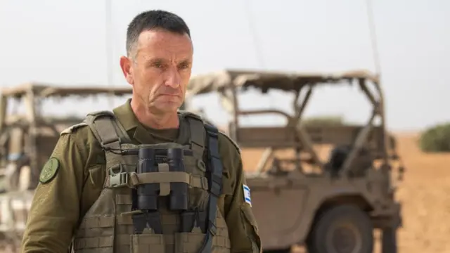 IDF chief of staff Herzi Halevi is shown standing in front of military equipment.