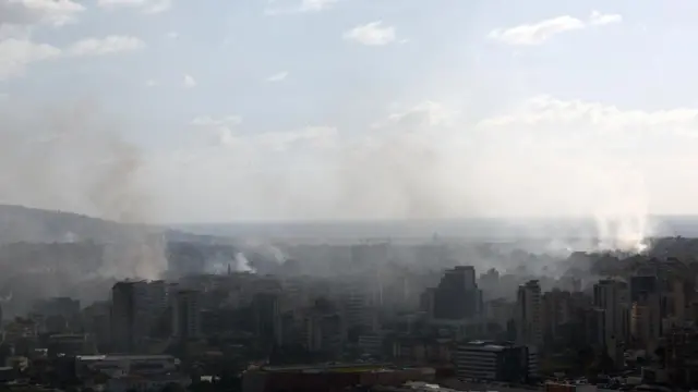 Smoke rises from an area densely packed with buildings