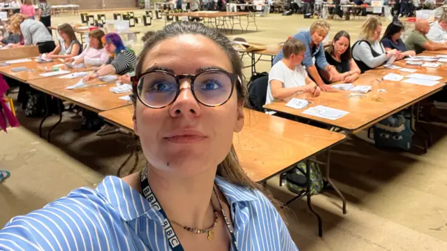 Ana Da Silva with ballot counting in background