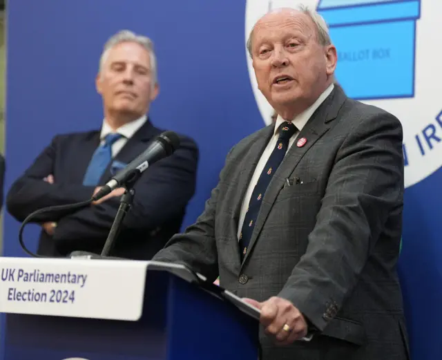 Men in suits at podium