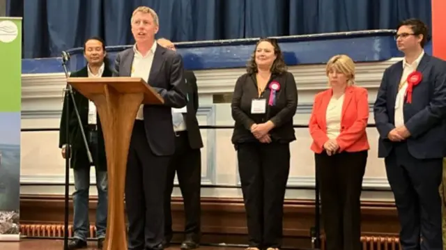 James MacCleary on the podium at the count