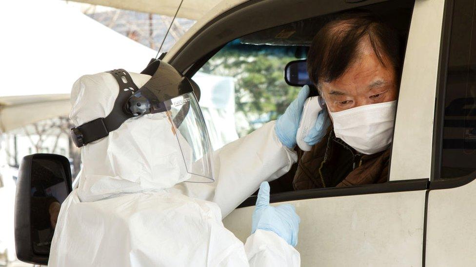 People are getting checked in their vehicles at a drive-through coronavirus clinic on February 27, 2020