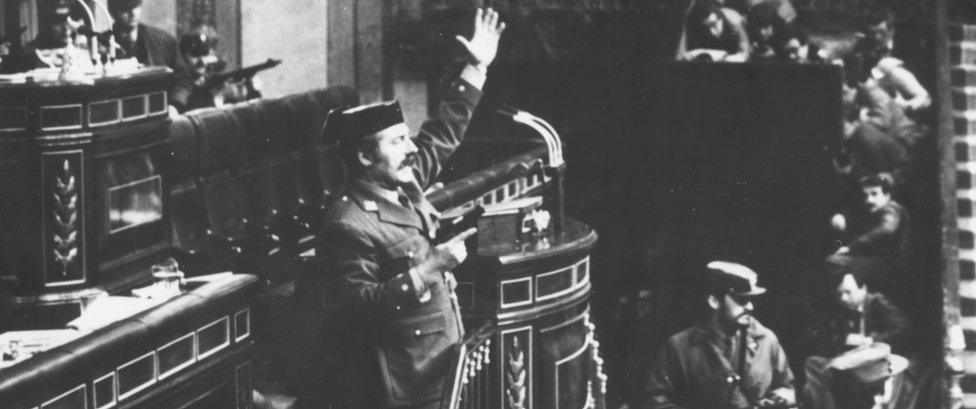 Colonel Antonio Tejero brandishing a gun as he attempts to take over Spanish parliament in a coup (Feb 1981)