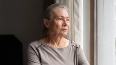 Older woman looking out the window