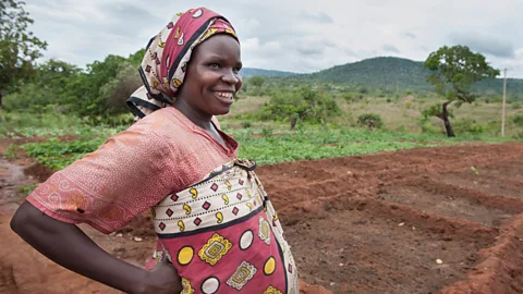 A pregnant woman taking a break from farming work (Credit: Alamy)