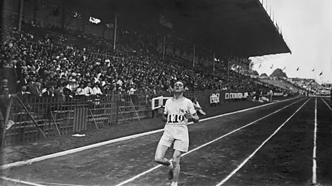 British athlete Ernie Harper crosses the finish line of the 1924 Paris Olympics cross-country race (Credit: Getty Images)