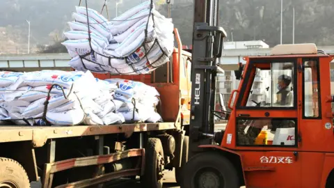 Getty Images Workers load bags of potassium chloride from Canada