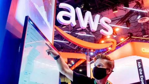 Getty Images An attendee demonstrates software during AWS re:Invent 2021, a conference hosted by Amazon Web Services