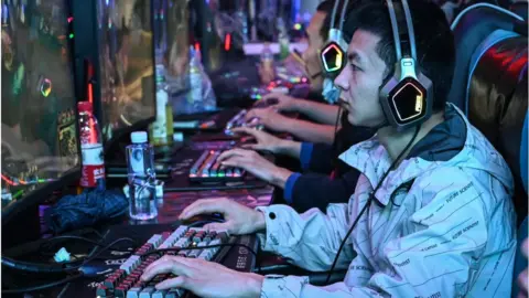 Getty Images People play video games at an internet cafe in Beijing on April 10, 2024.