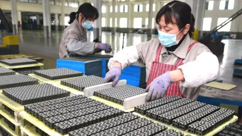 Getty Images A worker produces magnetic materials at Guanyouda Magnetic Industry Co