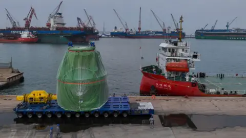Getty Images The core module of China's forthcoming commercial SMR being transported last summer