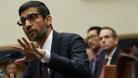 Getty Images Alphabet boss Sundar Pichai at a 2018 hearing in Washington. In July, he assured Congress, "We conduct ourselves to the highest standard".