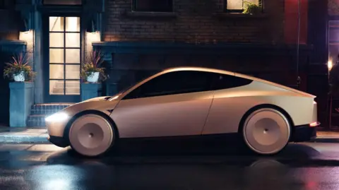 Tesla's Cybercab robotaxi parked on a dark, dimly lit street at the Warner Bros Studio in California