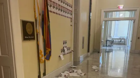 A hallway outside Rep Schneider's office showing the damaged posters