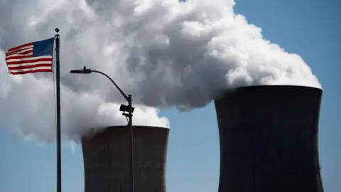 Steam rises out of the nuclear plant on Three Mile Island, with the operational plant run by Exelon Generation, in Middletown, Pennsylvania on March 26, 2019. 