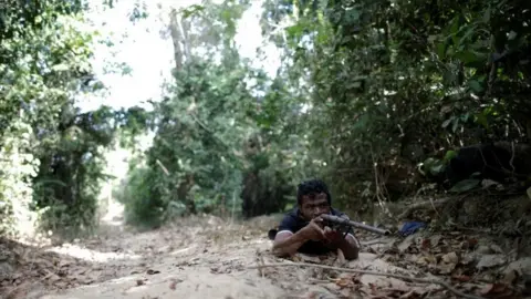 Reuters Paulo Paulino Guajajara holds a gun during the search for illegal loggers in September