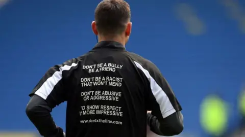 Getty Images Match officials at an England Premier League game last month wore T shirts bearing anti-abuse slogans.