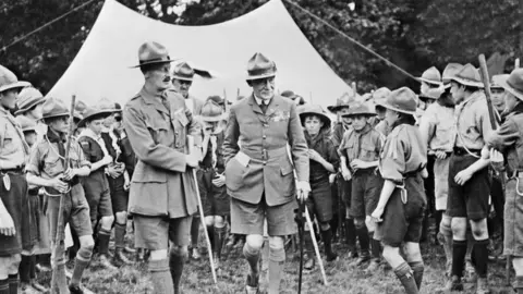 AFP/Getty Images Baden-Powell (C-R) surrounded by the members of the Boy Scout movement