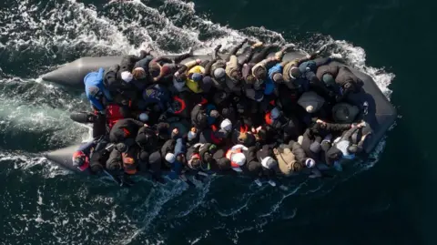 Getty Images An inflatable dinghy carrying around 65 migrants crosses the English Channel on March 06, 2024