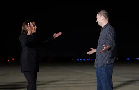 US Vice President Kamala Harris greets Evan Gershovich at  Joint Base Andrews in Maryland