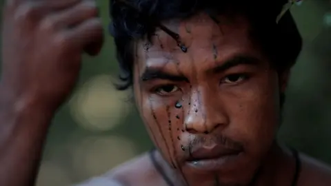 Reuters Paulo Paulino Guajajara applies face paint in September