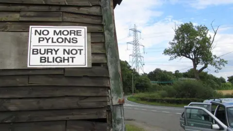 BBC Anti-pylons sign, with pylon in background