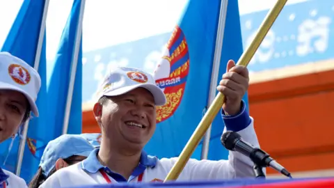 Reuters Hun Manet holds a banner at a CPP rally in July 2023 in Phnom Penh