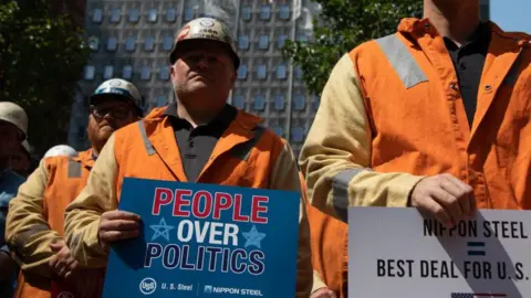 Steelworkers rally outside the company's headquarters in Pittsburgh, Pennsylvania, supporting the takeover by Japan's Nippon Steel, on September 4, 2024.