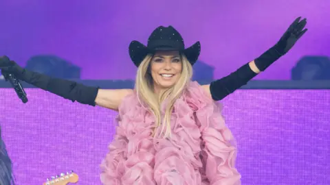 Shania Twain smiles as she performs at Glastonbury