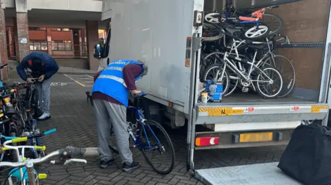 Bikes being loaded into a van