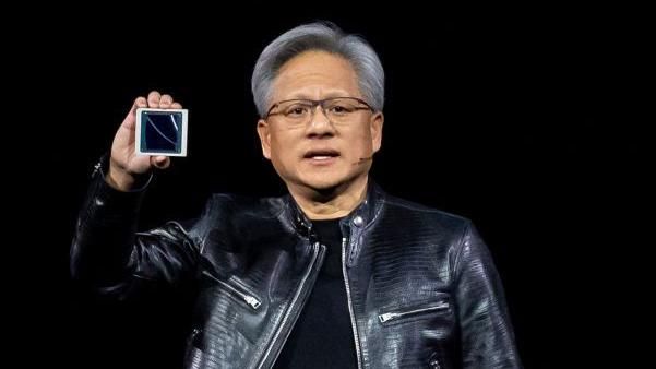 Jensen Huang, co-founder and chief executive officer of Nvidia Corp., displays the new Blackwell GPU chip during the Nvidia GPU Technology Conference (GTC) in San Jose, California, US, on Monday, March 18, 2024. 
