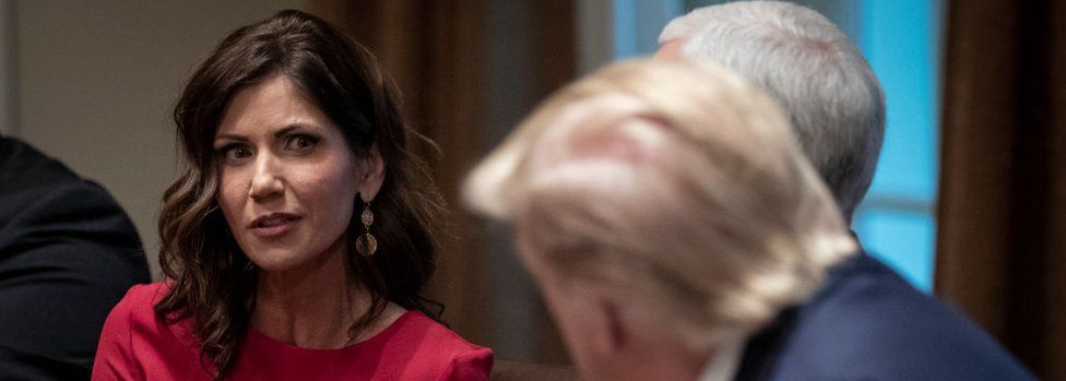 Kristi Noem speaks as Donald Trump listens during a meeting in the White House in December 2019