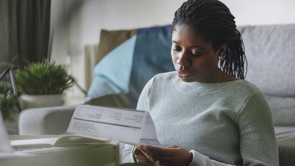 Woman looking at an energy bill