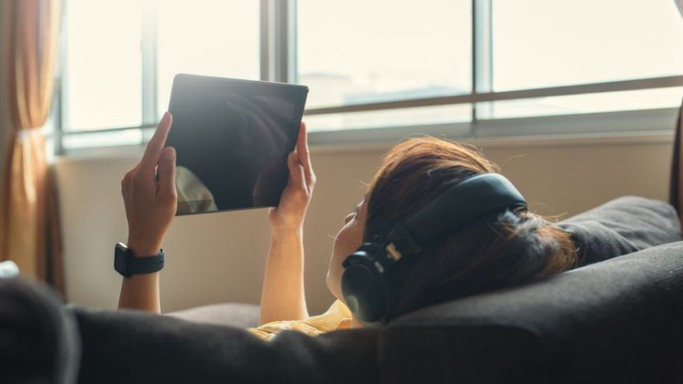 A woman watching a tablet device