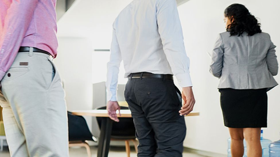 Office workers enter a meeting room