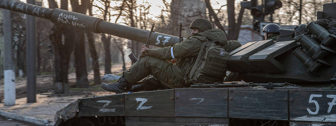 Pushing on: Russian soldiers sitting on a T-80 tank near the frontline