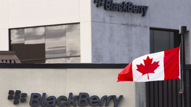 A Canadian flag waves in front of a Blackberry logo at the Blackberry campus in Waterloo